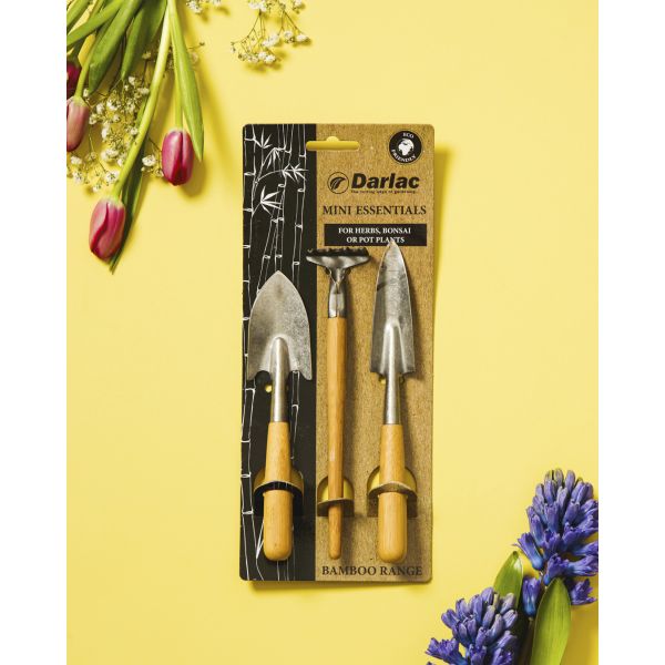 Darlac mini gardening tools set on a yellow background with flowers.