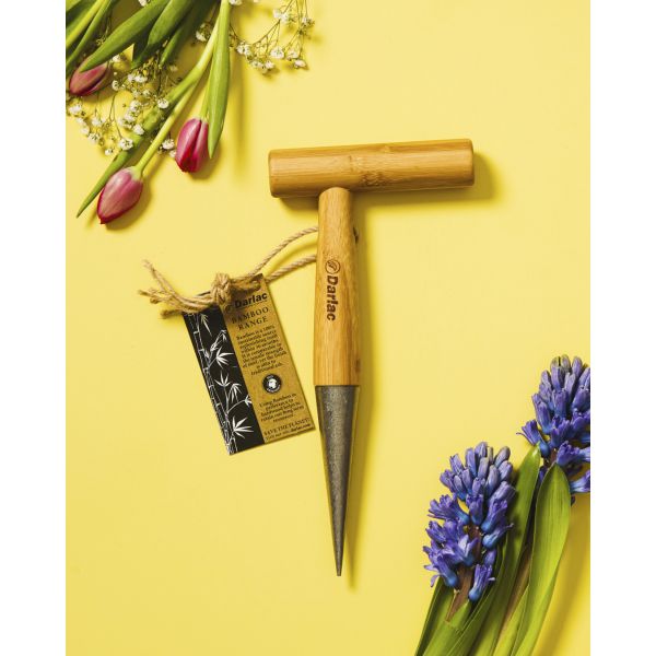 Wooden tool with a pointed end on a yellow background with flowers