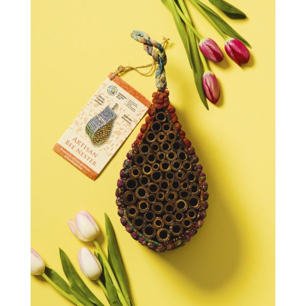 Decorative bee skep with tulips on a yellow background